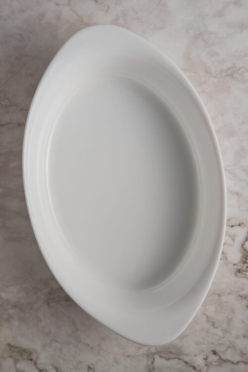 Plain white oval ceramic serving platter, elegant dinnerware for snacks or main courses.