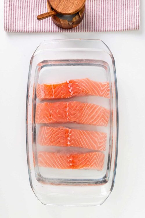 Fresh salmon fillets soaking in water for easy preparation.