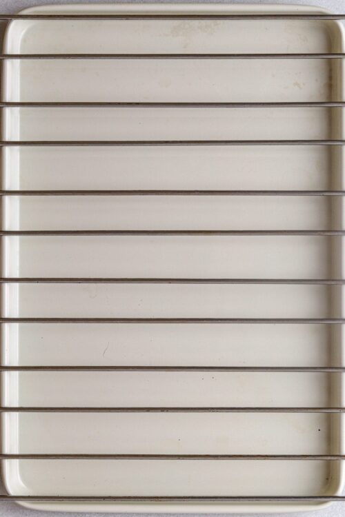 Metal cooling rack with silver bars for baking and cooling baked goods.