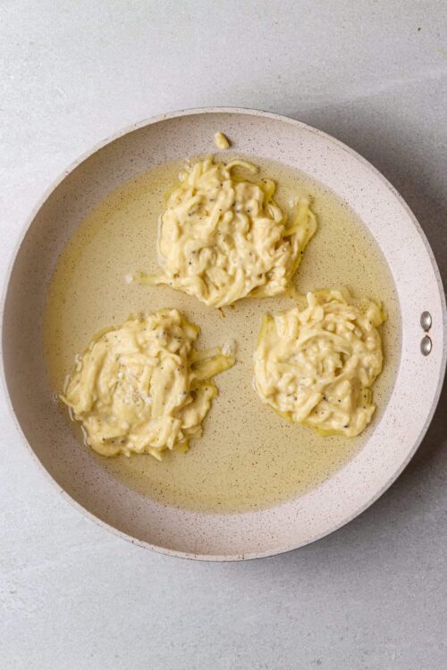 Creamy cheese-stuffed pasta parcels cooking in a skillet with butter, showcasing homemade Italian recipes.