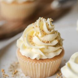 Buttercream cupcake with white frosting and gold sprinkles, baked for special occasions, delicious vanilla cupcake, bakery style sweet treat, Baked Bree.