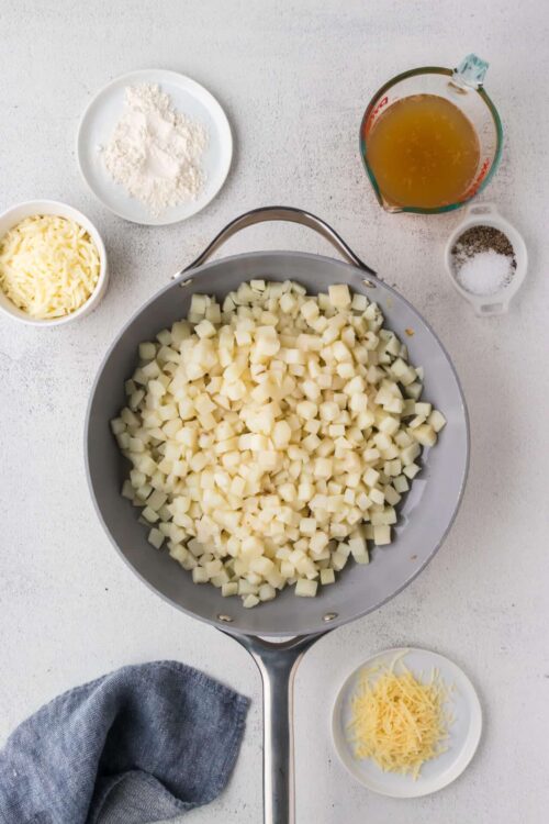 Chopped potatoes in a skillet for making potato hash or breakfast dishes.