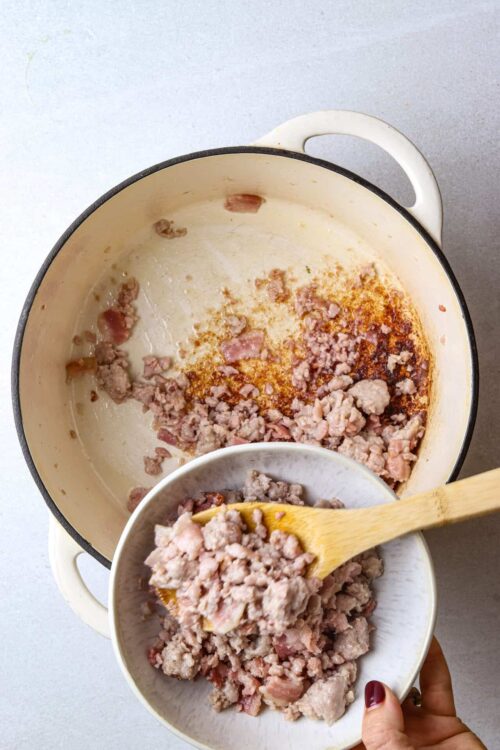 Cooked ground pork and bacon in a cast iron skillet for homemade savory breakfast recipes.