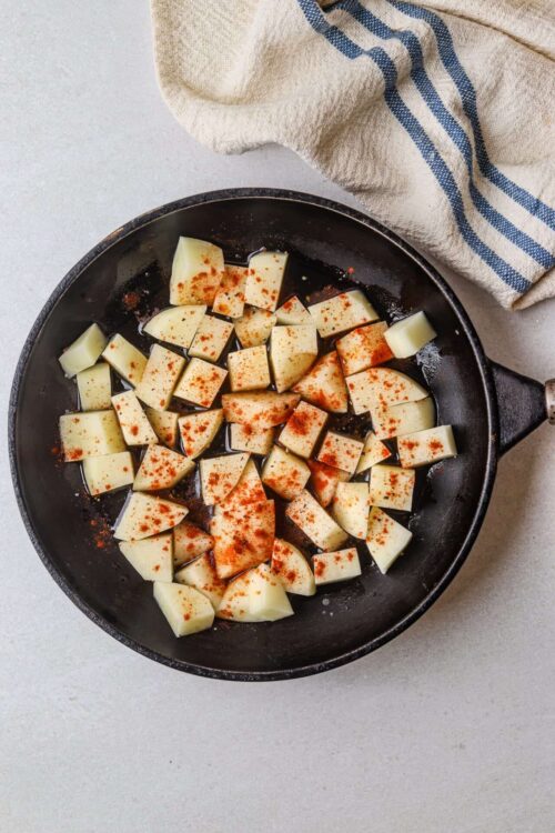 Creamy cubed potatoes seasoned with paprika, ready for cooking or roasting.