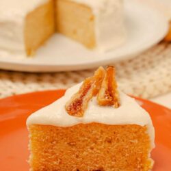 Buttered caramel cake slice with creamy frosting and pecan topping on orange plate, dessert perfect for celebrations, baked dessert recipe, bakery style cake.