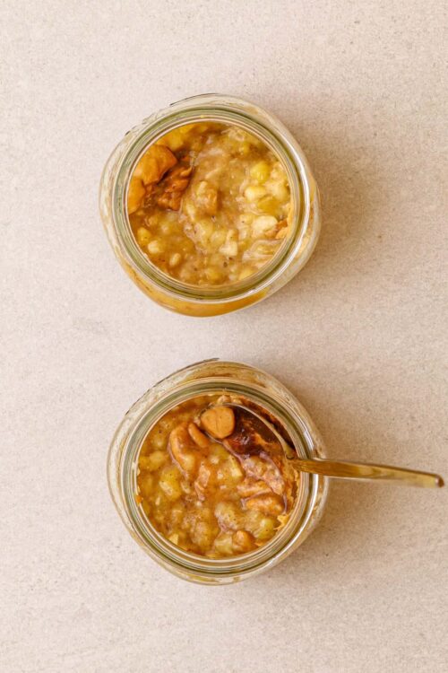 Homemade chicken and rice soup in glass jars with a spoon, comforting and hearty, perfect for cozy dinners.