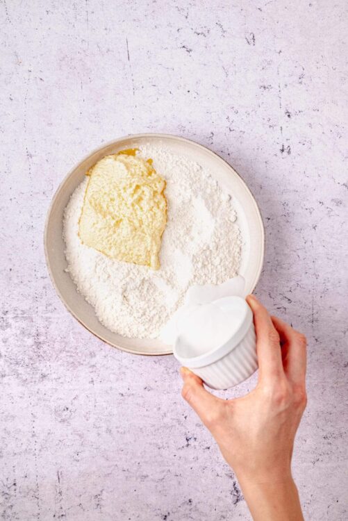 Flour, butter, and sour cream in a mixing bowl for baking.