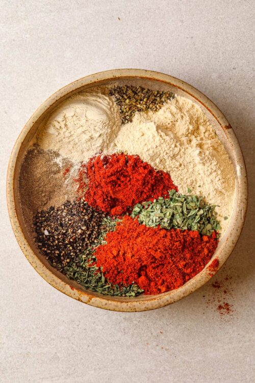 Mixed dried herbs and spices in a bowl for baking or cooking.