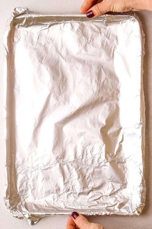 Aluminum foil-wrapped baking tray prepared for baking or roasting.