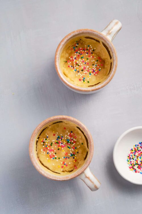 Sweet baked mug cakes topped with colorful sprinkles for quick and easy dessert recipes.