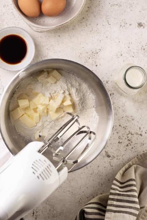 Cream cheese and butter for baking on a textured surface.