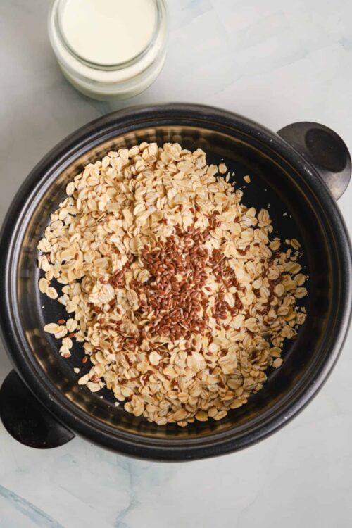 Crunchy oatmeal with flax seeds in a slow cooker, ready for baking or cooking.