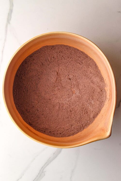 Decadent chocolate cake in a wooden bowl for baking or desserts.