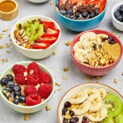 Fresh fruit smoothie bowls topped with strawberries, blueberries, bananas, and granola. Healthy, colorful, and delicious breakfast ideas.