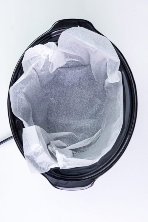 Unlined baking pan with parchment paper for easy baking cleanup.