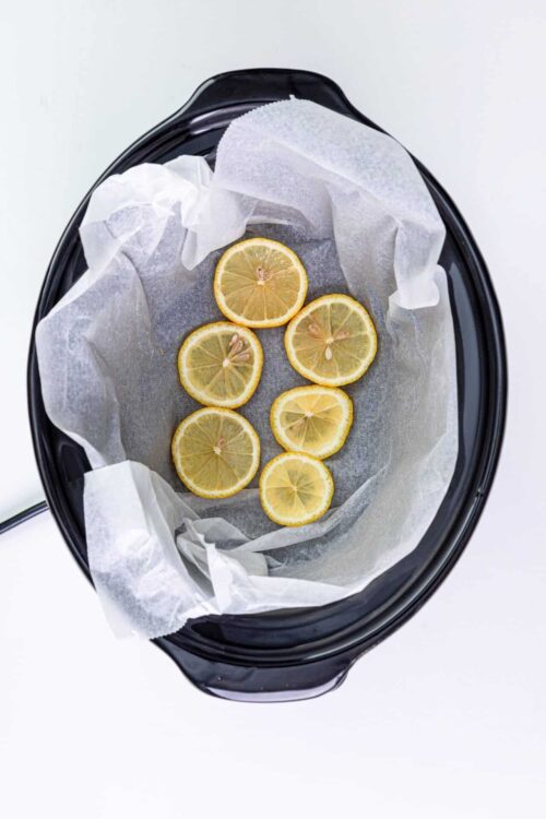 Lemon slices in a food dehydrator for homemade fruit snacks or lemon chips.