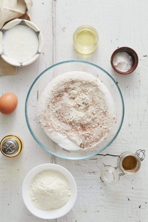 All-purpose flour in a glass mixing bowl with baking ingredients for baking bread or pastries.