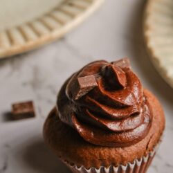 Decadent chocolate cupcake with rich frosting and chocolate chunks, perfect for baking and dessert recipes.