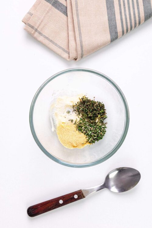 Fresh herbs and spices in a glass bowl for baking or cooking.