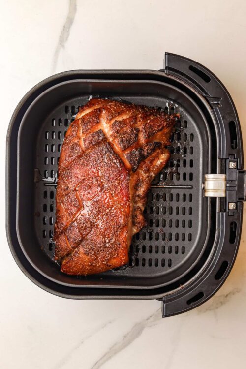 Succulent cooked steak in air fryer with crispy seasoned crust.