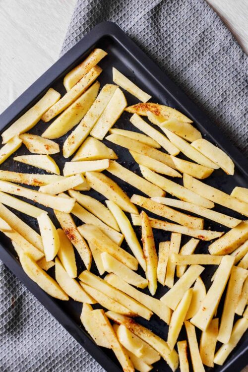 French fries on baking sheet with seasoning | Baked Bree.