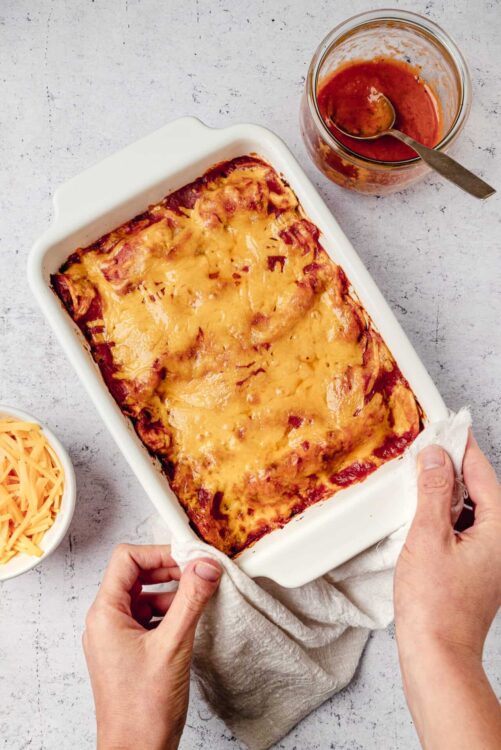 Savory baked lasagna with melted cheese in a white baking dish.
