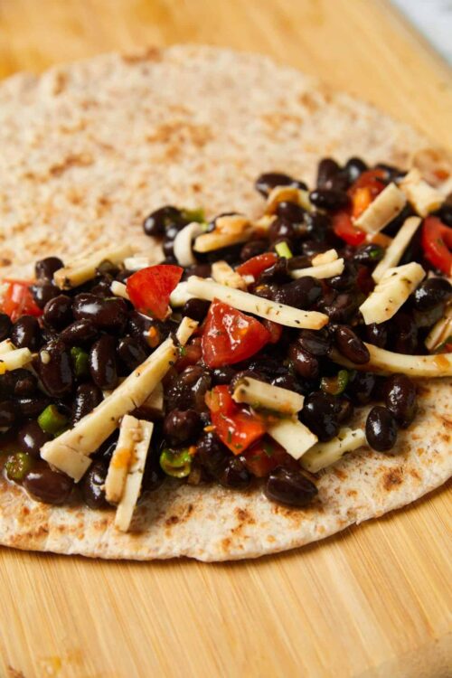 Savory black bean and cheese vegetarian fajita pizza on flatbread.