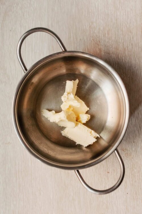 Butter in a stainless steel mixing bowl, baking ingredients, butter for baking recipes.