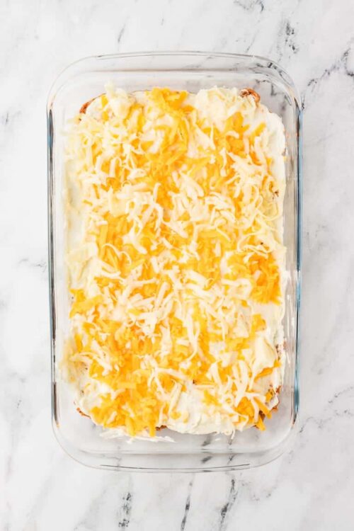 Baked cheesy potato casserole in glass dish.