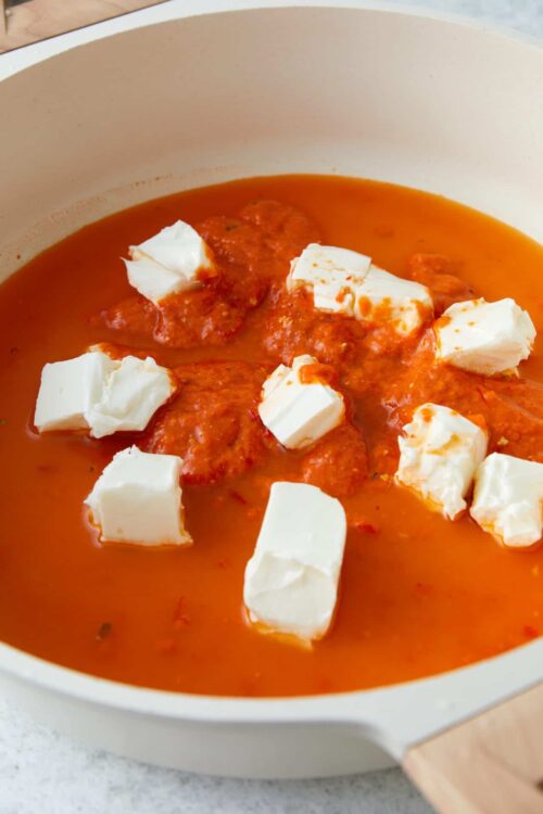 Creamy tomato soup with mozzarella cheese in a white bowl, comfort food recipe.