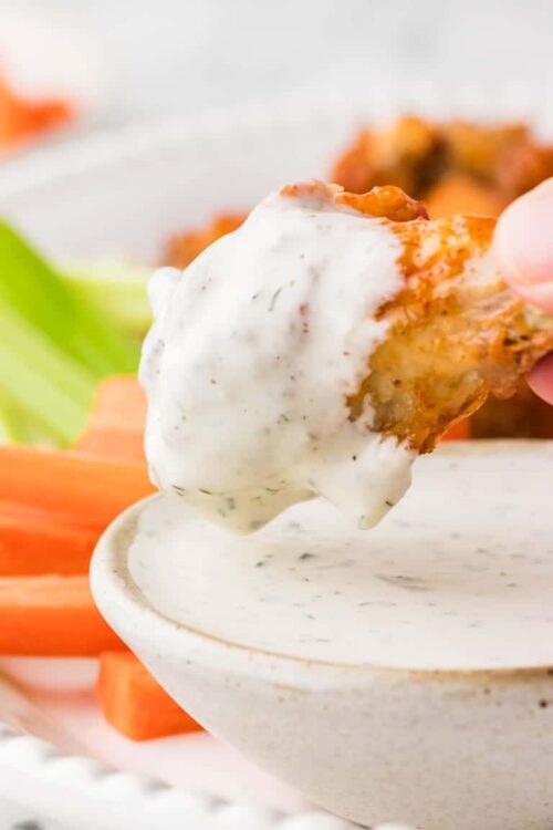 Creamy ranch dipping sauce with a crispy chicken wing. Perfect for appetizers and game day snacks.