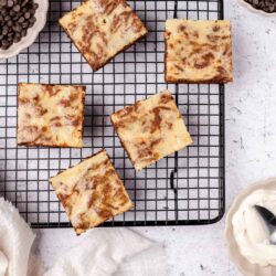 Butterscotch chip blondies with chocolate chips on cooling rack.