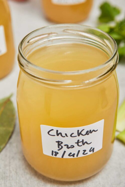 Creamy homemade chicken broth in a glass jar, perfect for soups and cooking.