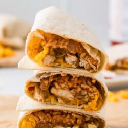 Homemade chicken breakfast burritos with scrambled eggs, cheese, and sausage.