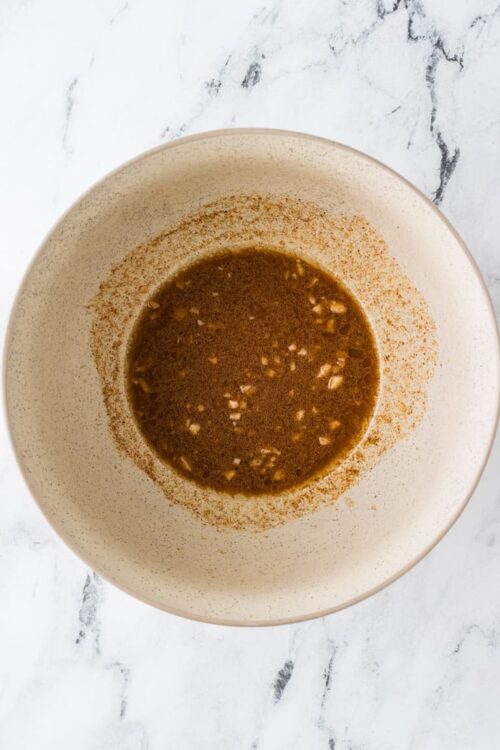 Savory garlic marinade in a white bowl ready for cooking or marinating.