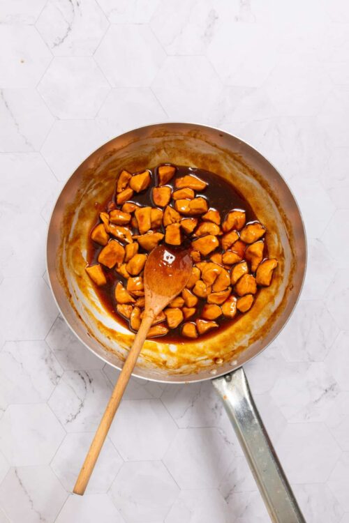 Sweet and savory chicken in skillet simmering with sauce, homemade chicken recipe.