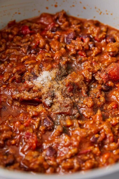 Savory homemade chili with ground beef, tomatoes, and spices in a cooking pot.