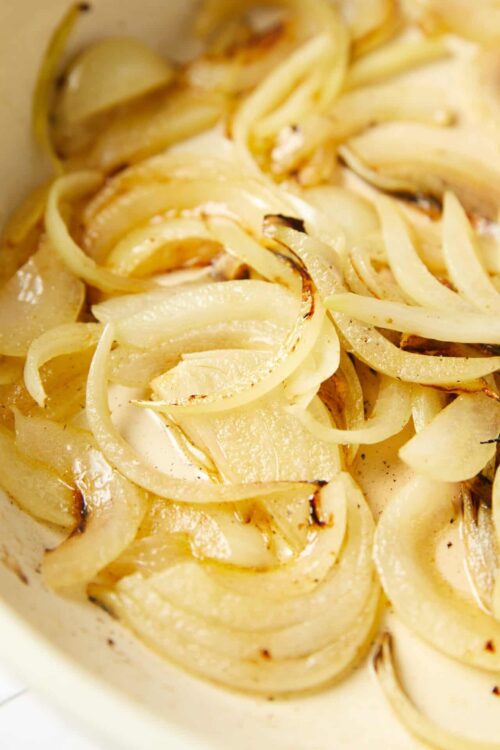 Golden caramelized onion slices cooked to perfection in a creamy sauce.