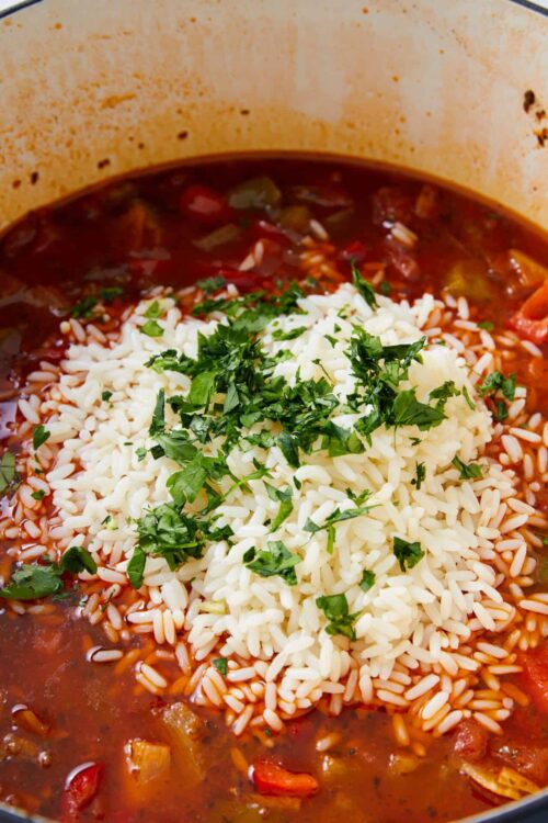Chili with rice and fresh herbs in a pot, hearty comfort food, baked Bree.