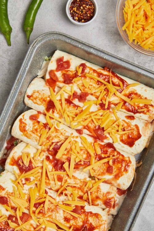 Baked cheese garlic bread with tomato sauce in baking dish.