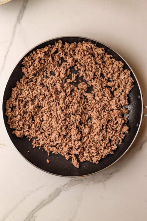 Ground beef cooking in a skillet, perfect for recipes like tacos or meat sauces.