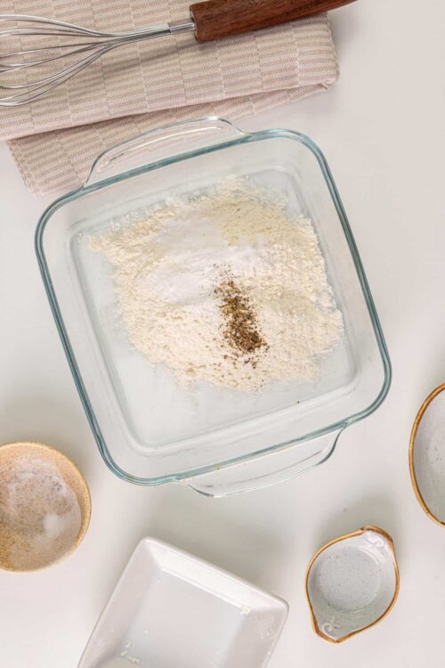 Flour, spices, and baking ingredients in a glass dish for baking recipes.