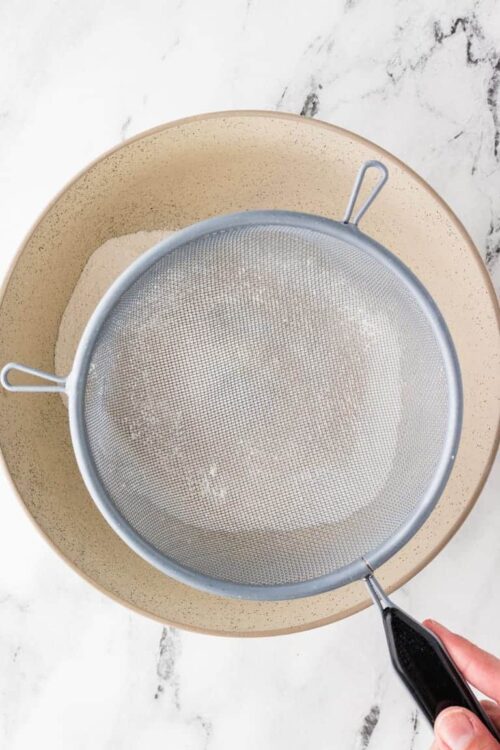 Baked Bree flour sifter and mixing bowl for baking ingredients preparation.
