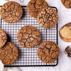 Soft and chewy ginger cookies cooled on a wire rack. Perfect for holiday baking and festive cookie exchanges.
