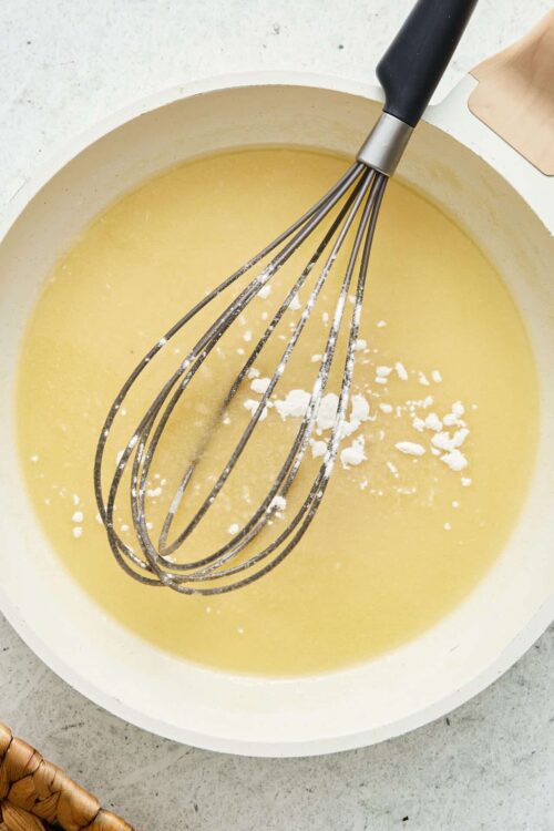 Creamy butter mixture with a whisk ready for baking.