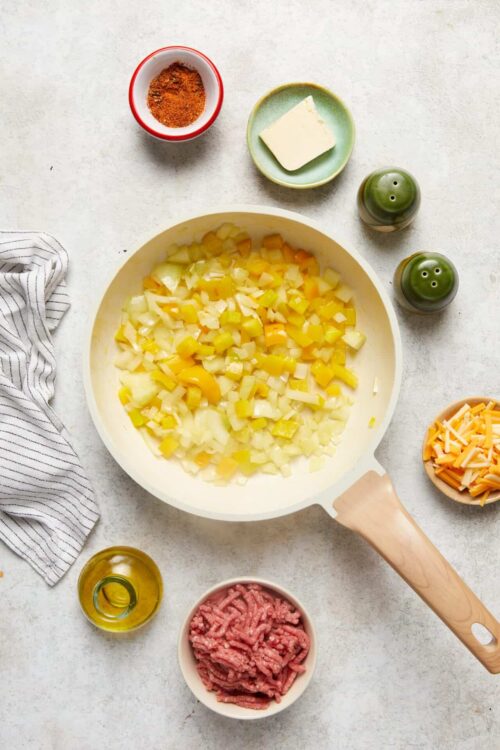 Chopped onions, garlic, and ground beef for easy ground beef recipes. Fresh spices and ingredients ready to cook.