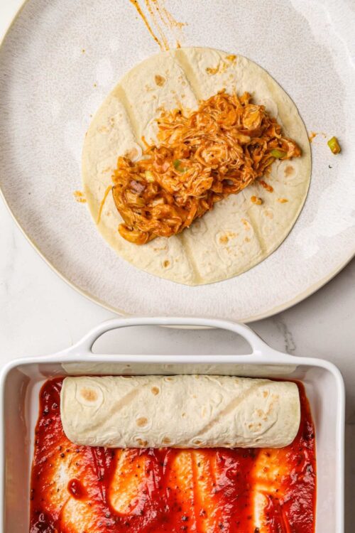 Shredded chicken and cheese filling inside a flour tortilla for burritos.