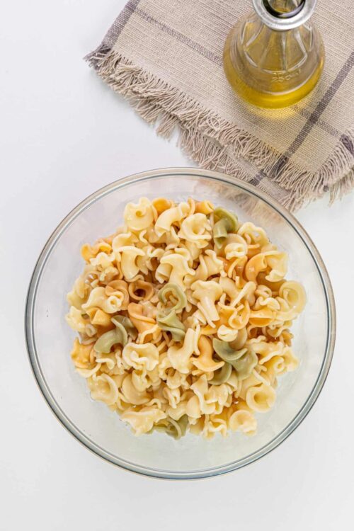 Colorful tri-colored pasta in a glass bowl.