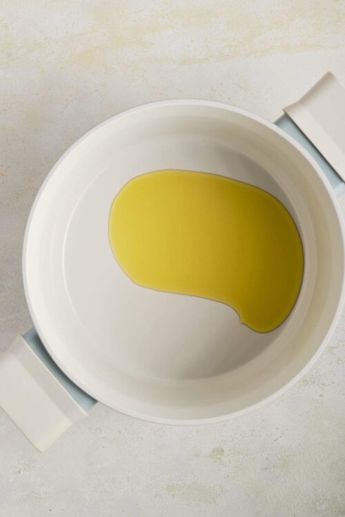 Golden olive oil in a white bowl for baking or cooking recipes.