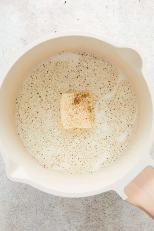 Creamy mixture with butter and spices in a white mixing bowl for baking or dessert recipes.